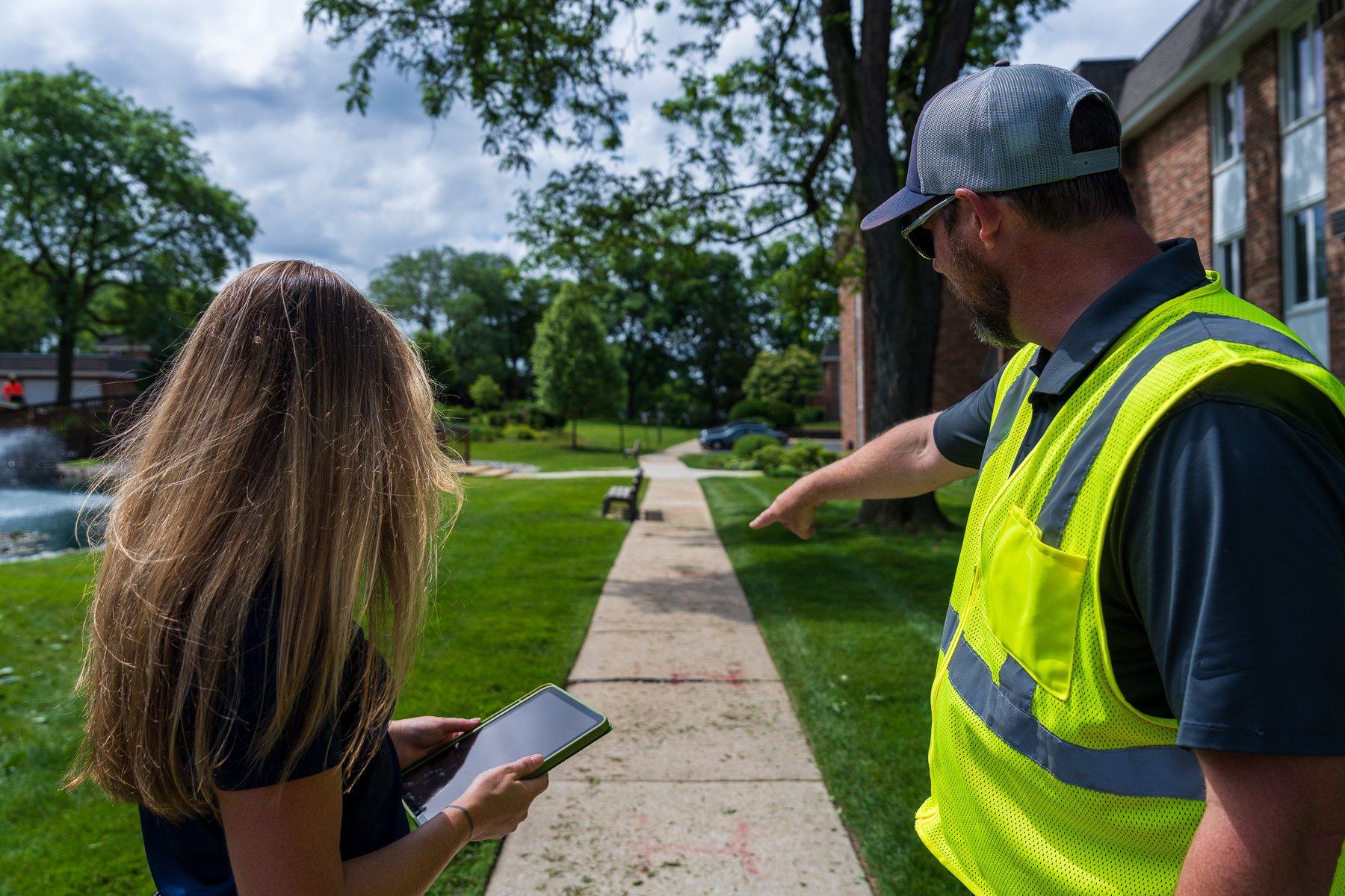 account manager and crew pointing at landscape