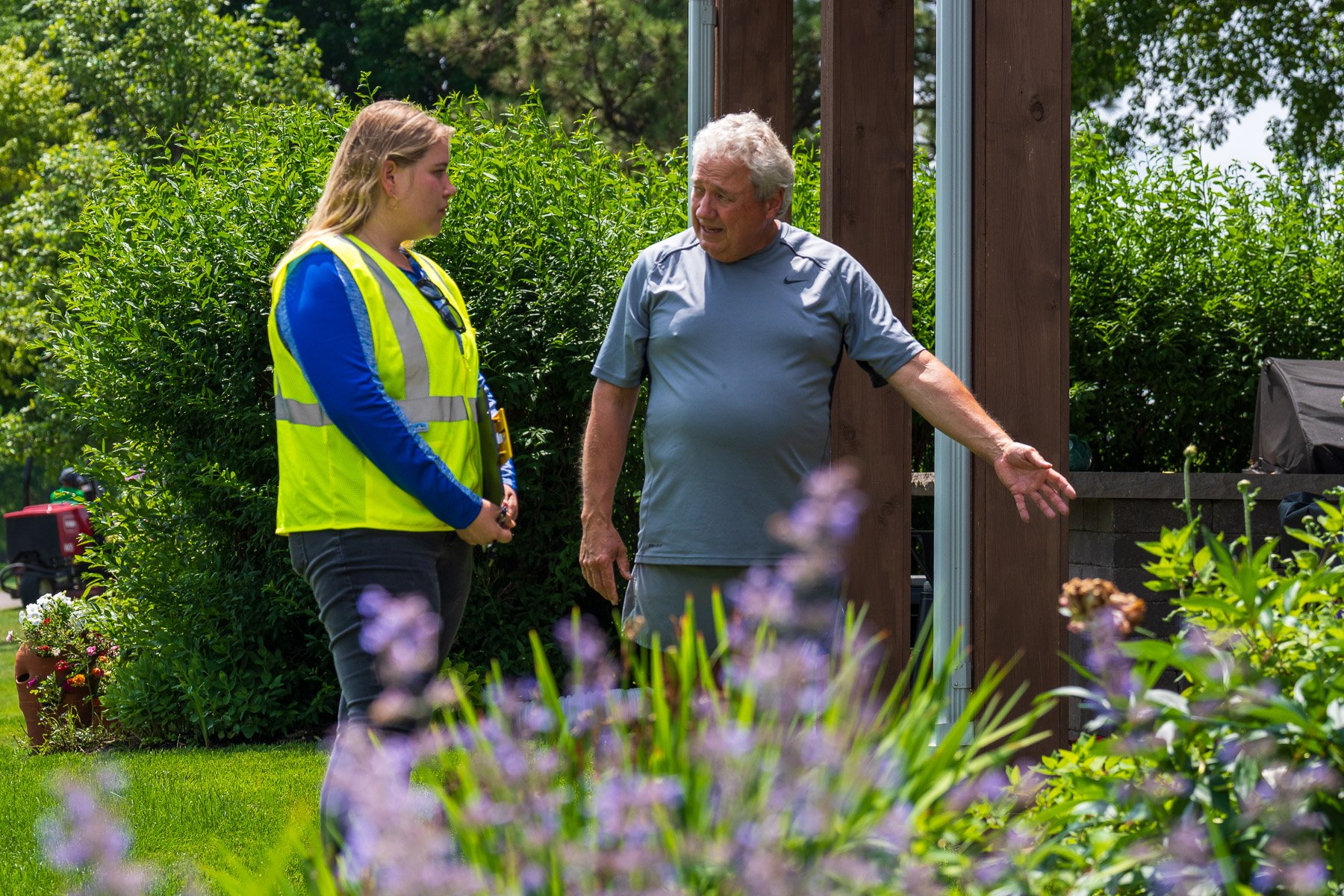 account manager talking to homeowner green lawn 3