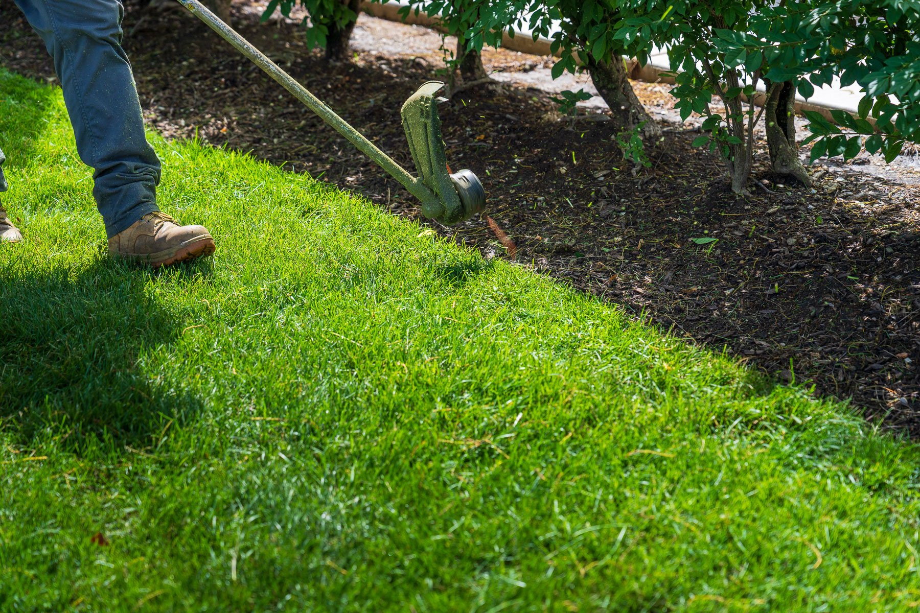 crew edging lawn along landscape beds