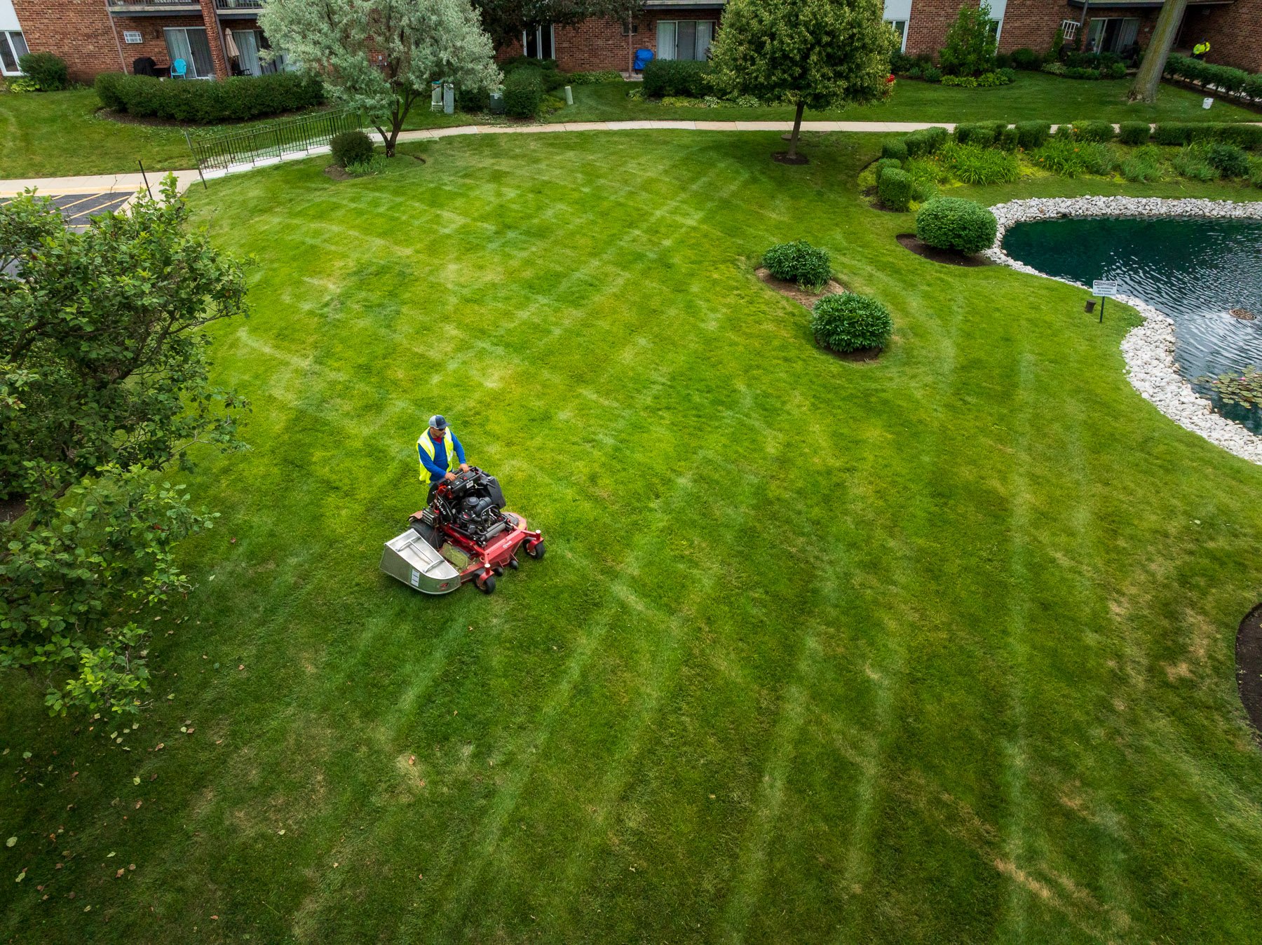 landscape maintenance crew mowing green lawn 2