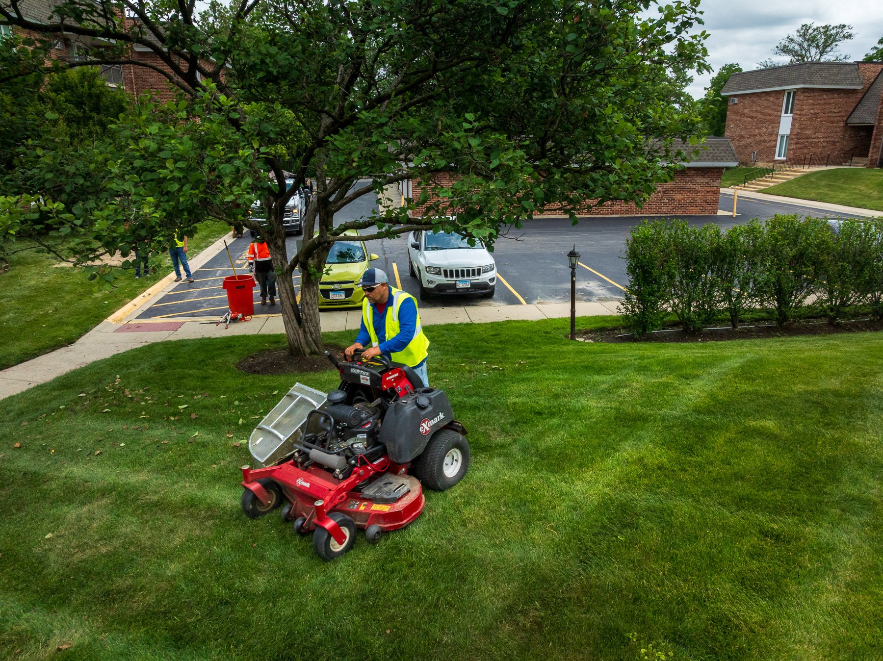 landscape maintenance crew mowing green lawn 3
