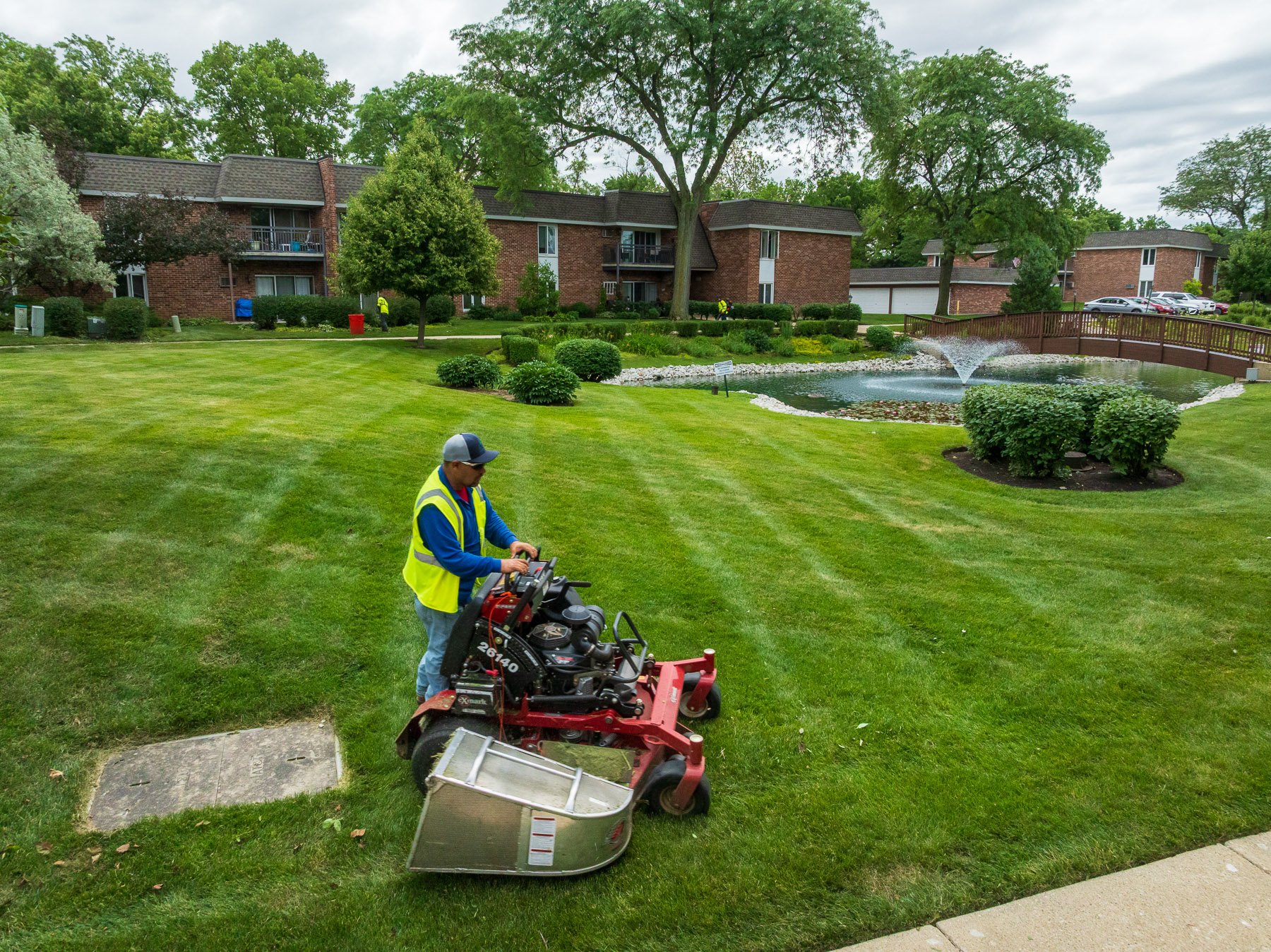 landscape maintenance crew mowing green lawn 4